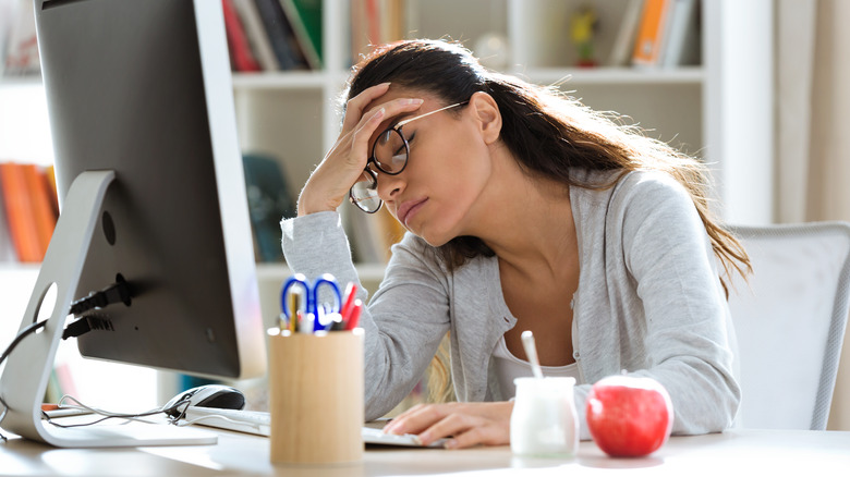 Woman falling asleep at desk