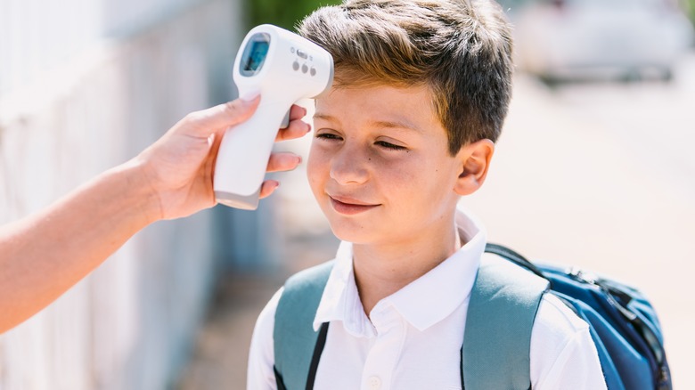 remote thermometer being used on child