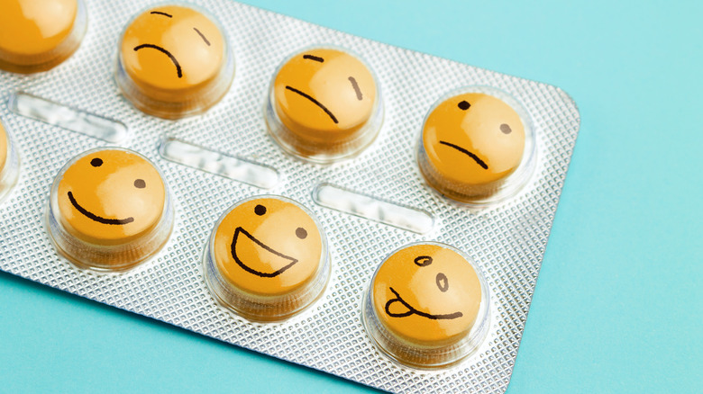 Close up of medication blister pack with faces drawn over the pills