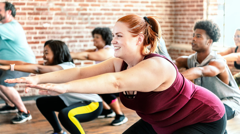 a group of people squat pulsing 