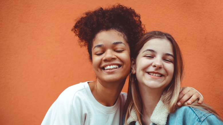 two girls smiling together