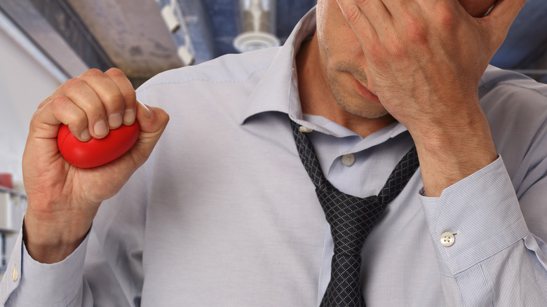 Stressed man holding stress ball