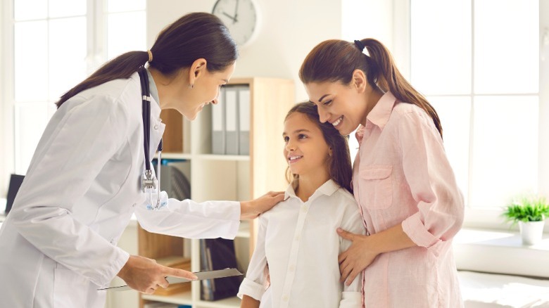 mom and daughter visit pediatrician