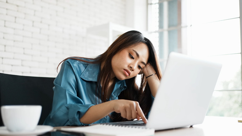 woman falling asleep at computer