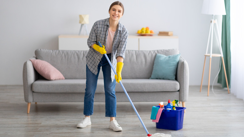 smiling woman mopping floor