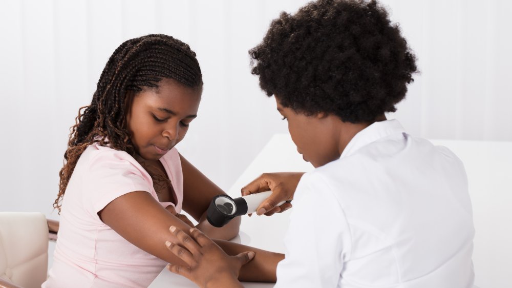 African-American girl seeing dermatologist
