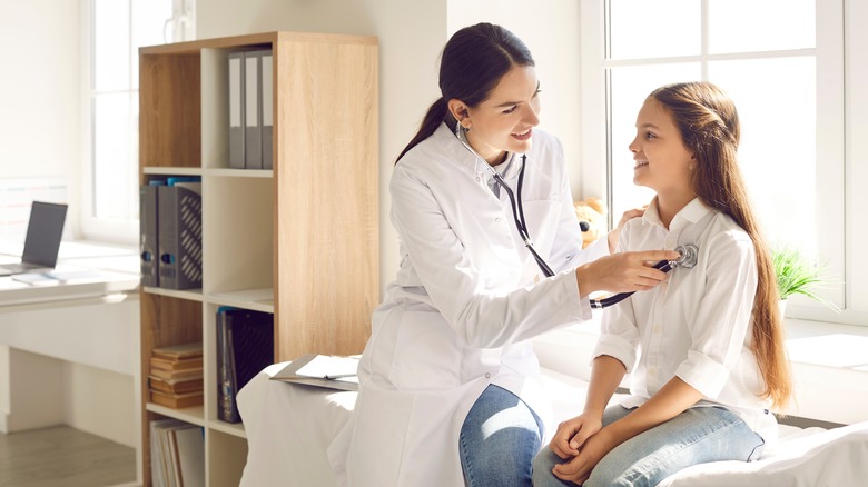 doctor examining young patient