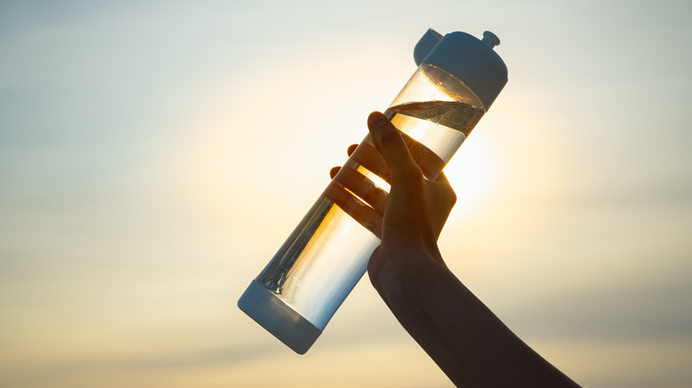 Hand holding water bottle