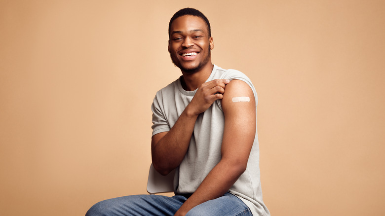 Young black man with bandage after getting vaccinated