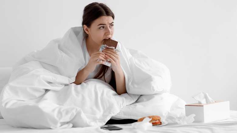 woman eating in bed