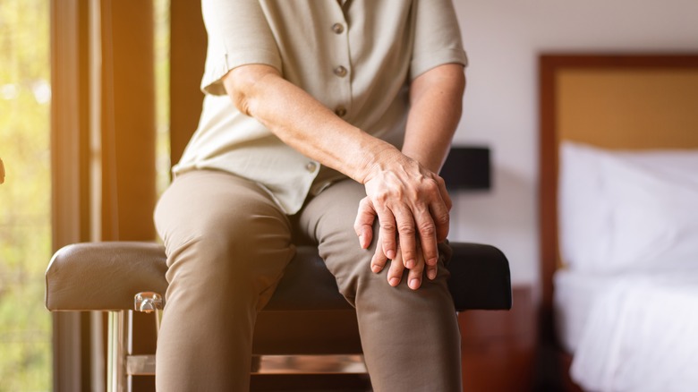 woman holding her knees