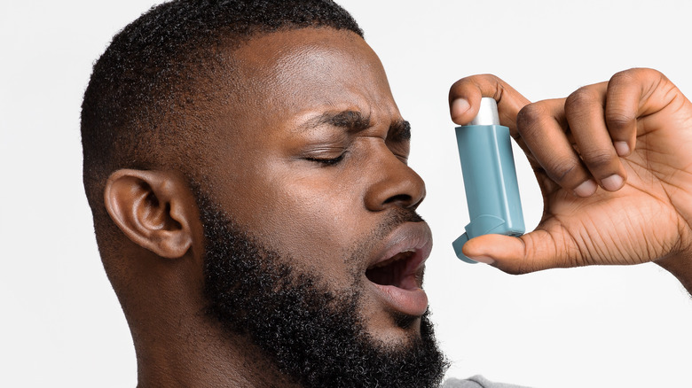 Black man using inhaler