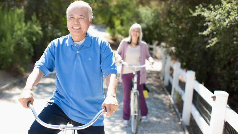 Happy senior couple riding bikes