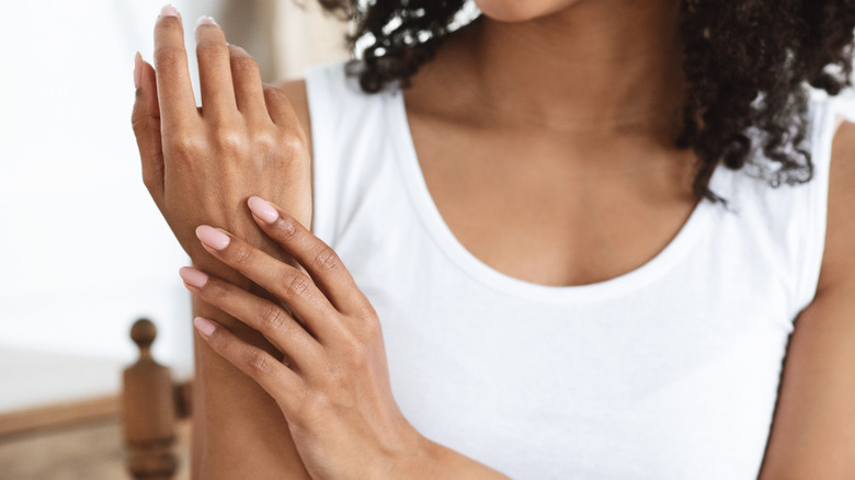 Woman moisturizing hands
