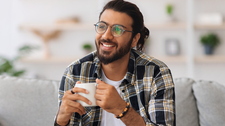 Smiling man holding mug