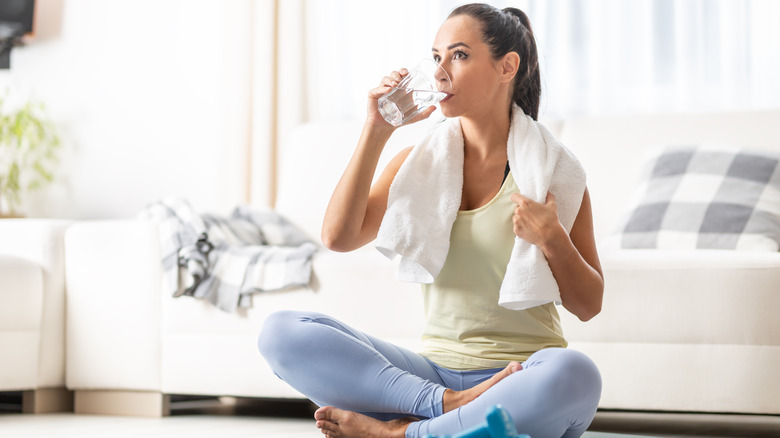 Woman drinking water during exercise
