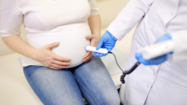 Doctor using fetal Doppler