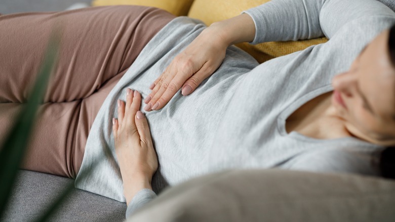 Woman holding pelvic area