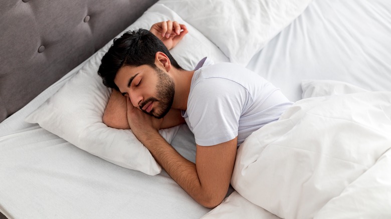 man sleeping peacefully in bed