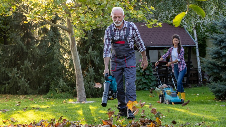 old man gardening with granddaughter