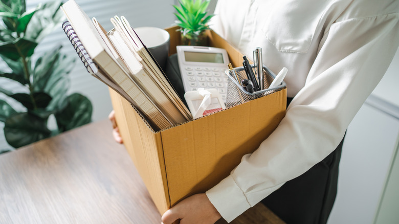 Person packing up boxes after losing job