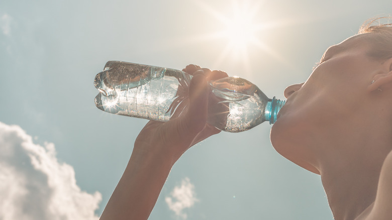 woman drinking water in the hot sun