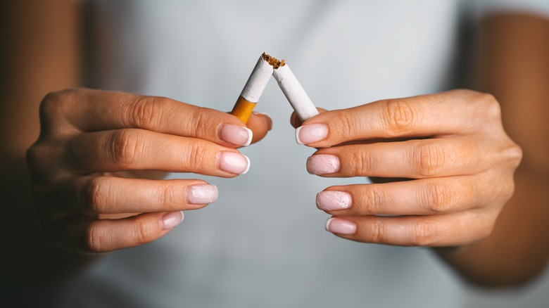 Hands breaking a cigarette