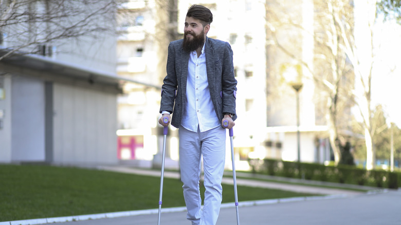 younger man walking with a cane