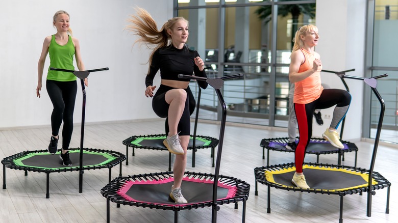 three women jumping on mini-trampolines for fitness