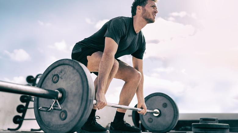 a man lifting a barbell 