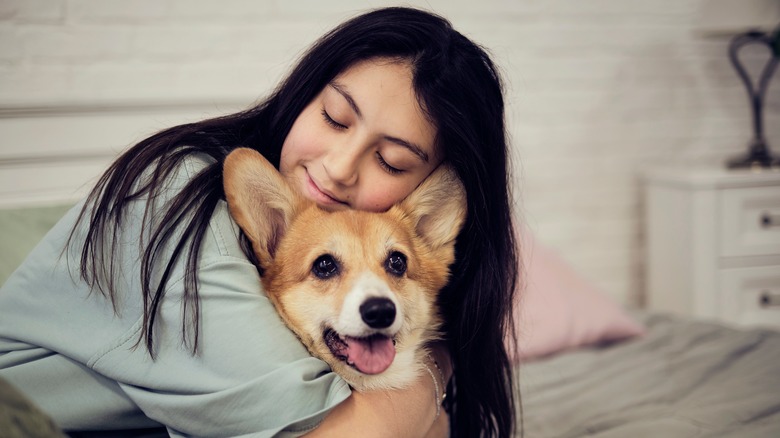Young woman hugging her dog