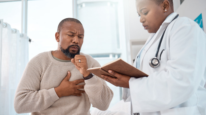 Coughing man speaking with doctor