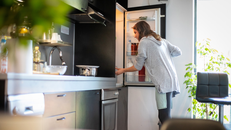 person opening fridge