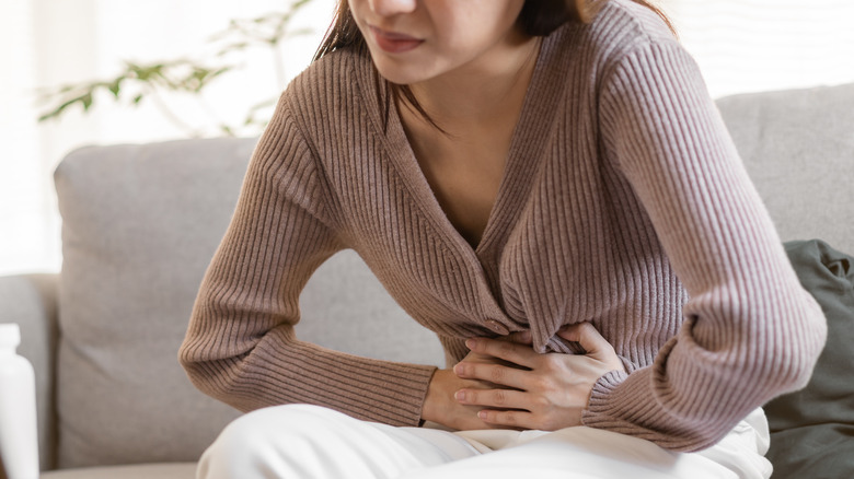 woman holding stomach