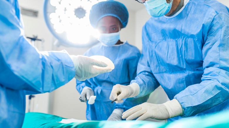 surgeons performing breast implant operation