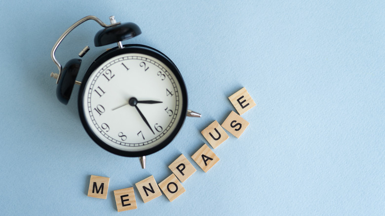 clock with blocks spelling menopause
