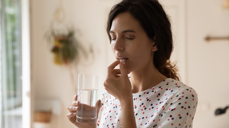 woman taking medication