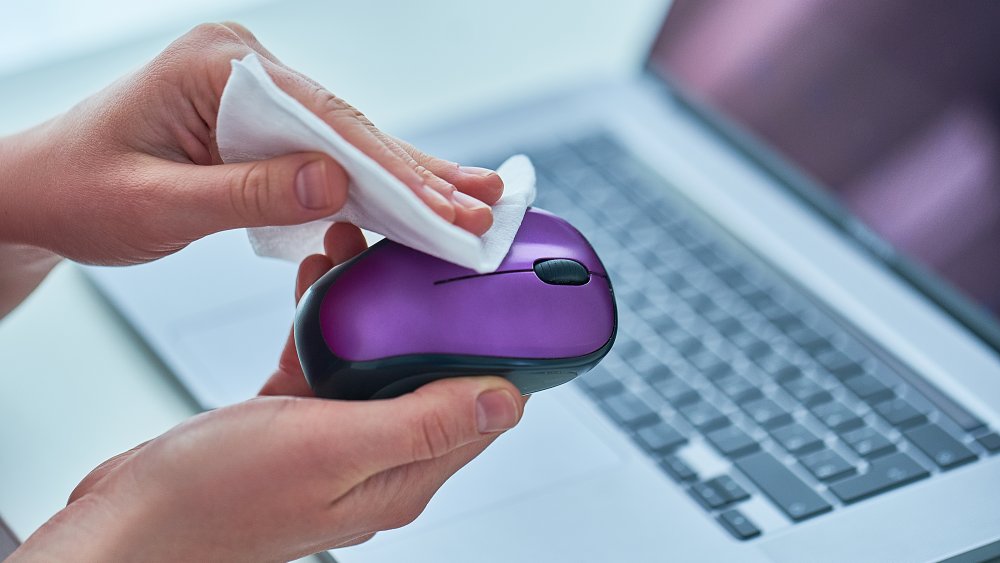 Person wipes off computer mouse
