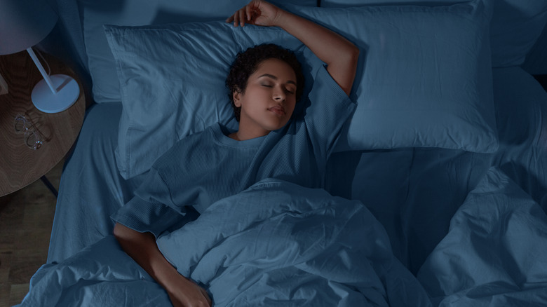 Young woman asleep in bed