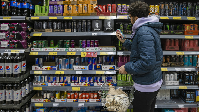 man shopping for energy drinks