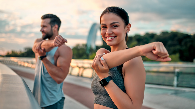 Man and woman stretching together