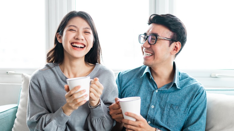 couple laughing together on couch