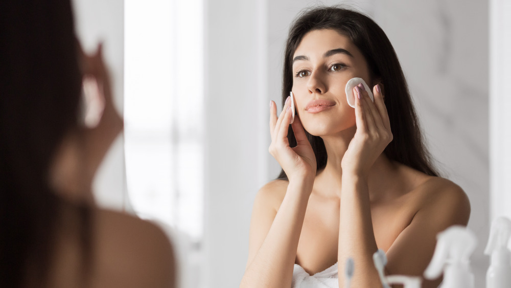 Woman using micellar water 