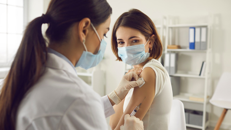 a doctor giving a patient the vaccine 