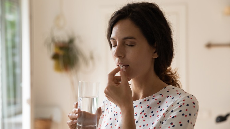 woman taking melatonin supplements