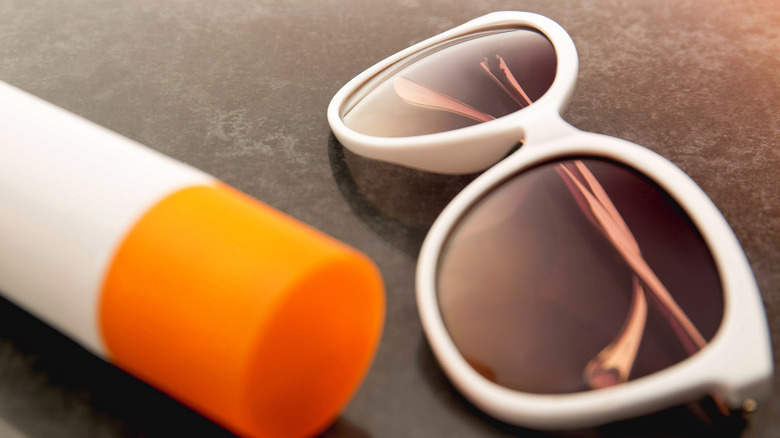 sunglasses and tube of sunscreen 