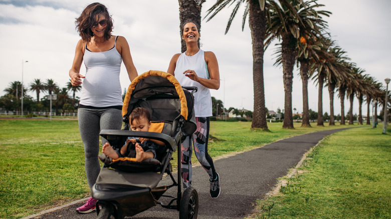 Smiling pregnant couple walking outside