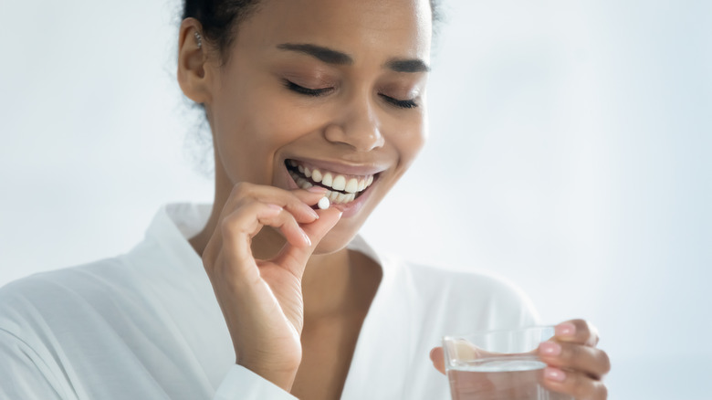 woman taking supplement