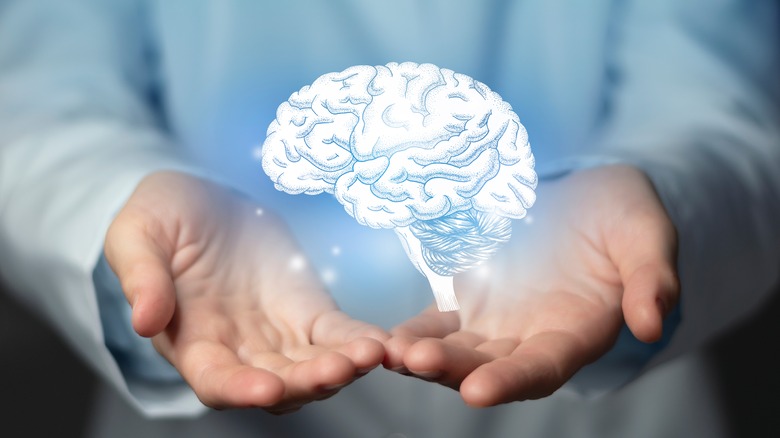 neurologist with brain graphic in hands