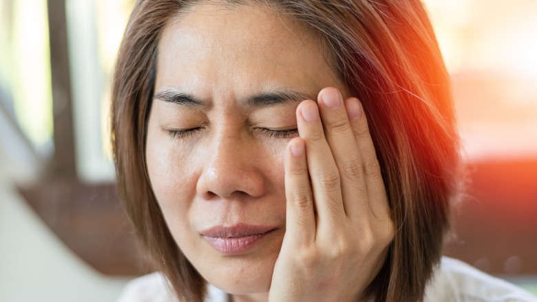 a woman with facial pain